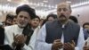 Hashmat Karzai (R) with Afghan presidential candidate Ashraf Ghani during a campaign event in Kandahar on June 6, 2014. 