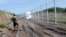 A Hungarian soldier carries a border sign to install at a fence near the town of Morahalom, at the Serbian border, on August 24.