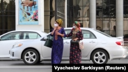 Women wearing face masks cross a street in the Turkmen capital, Ashgabat.