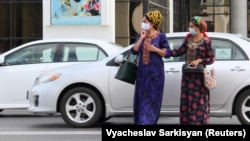 Women wear face masks as a preventive measure against the spread of COVID-19 in Ashgabat despite claims by the Turkmen government that the virus does not exist there. 