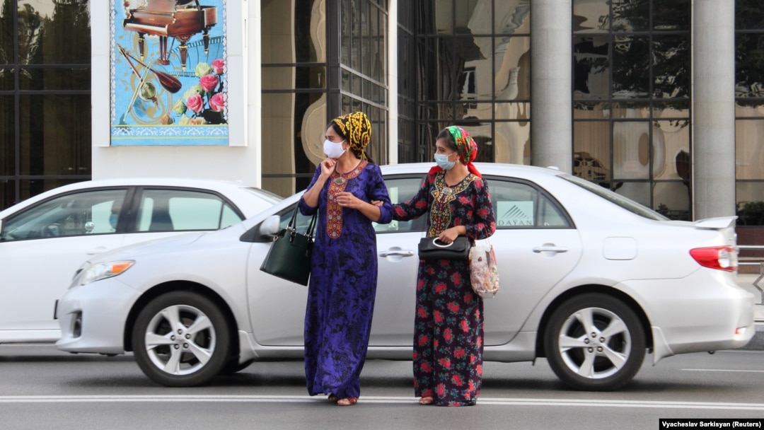 Women wearing face masks cross a street in the Turkmen capital, Ashgabat.