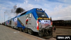 A train gets moving during the inauguration of a new line linking eastern Iran and western Afghanistan at a railway station in the Iranian town of Khaf on December 10. 