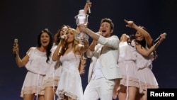 Ell and Nikki of Azerbaijan celebrate on stage after winning the Eurovision Song Contest final in Duesseldorf in May 2011.