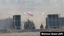 A Russian Army vehicle enters Syria as it begins its joint patrol with Turkish forces on November 5.