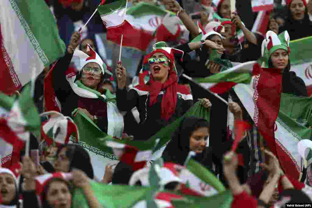 Iranian women cheer during a soccer match between their national team and Cambodia in a World Cup qualifier at the Azadi Stadium in Tehran. (AP/Vahid Salemi)