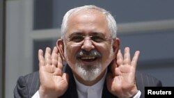 Iranian Foreign Minister Mohammad Javad Zarif gestures as he talks to journalist from a balcony of the Palais Coburg Hotel where the Iran nuclear talks are being held in Vienna on July 10.