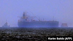 Tug boats are moored next to the Mercer Street off the United Arab Emirates' coast on August 3.