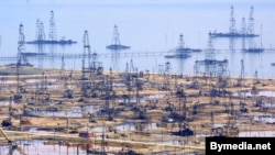 Oil derricks on the shore of the Caspian Sea just outside the Azerbaijani capital, Baku.