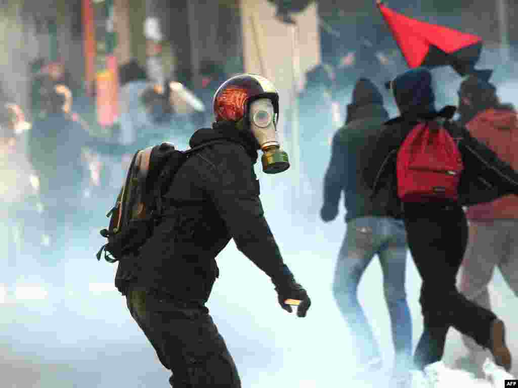 Greece wracked by protests. - A protester throws stones at riot police during a demonstration outside of a regional government ministry office in the northern Greek city of Thessaloniki on December 10, 2008. Protestors hurled rocks today at security forces in Greece's second city of Thessaloniki and were fought off with tear gas, police said.