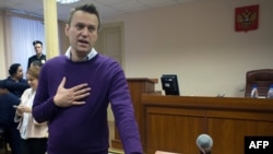 Russian anticorruption blogger Aleksei Navalny gestures during a court hearing in Kirov on December 5.