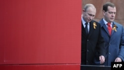 Russian President Vladimir Putin (left) and Prime Minister Dmitry Medvedev arrive to watch Victory Day parade at Red Square in Moscow on May 9.