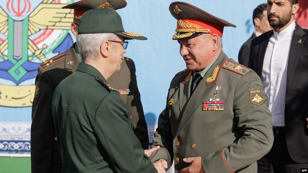 Russian Defense Minister Sergei Shoigu meets with the chief of staff of Iran's armed forces, Mohammad Bagheri, in Tehran on September 19.