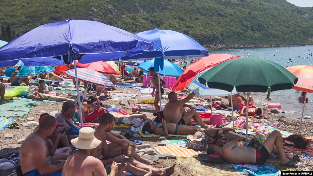 Beachgoers seek the shade in Canj, Bar municipality, Montengro.