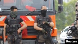 Members of the police special forces stand guard in front of the Air Force Academy in Istanbul, Turkey.