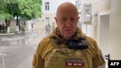 A video grab from handout footage posted on June 24 shows Yevgeny Prigozhin speaking inside the headquarters of the Russian southern military district in the city of Rostov-on-Don. 