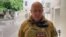 A video grab from handout footage posted on June 24 shows Yevgeny Prigozhin speaking inside the headquarters of the Russian southern military district in the city of Rostov-on-Don. 