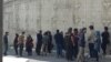 Family members of detained labor activists outside Tehran's notorious Evin prison where most protesters and dissidents are kept. Undated. 