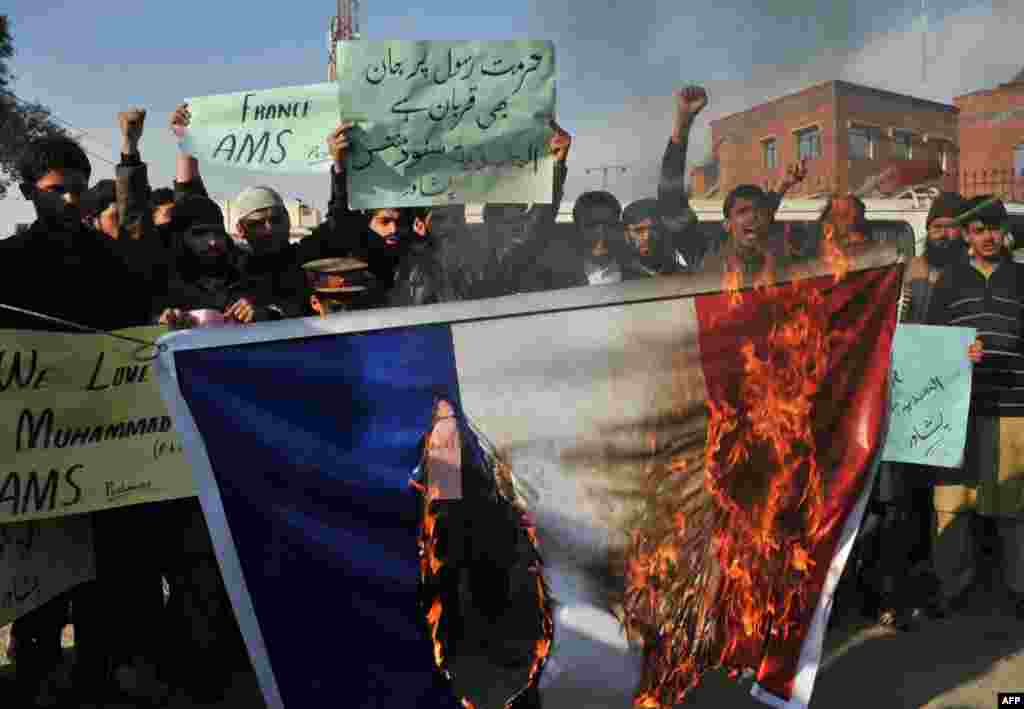 Pakistani demonstrators &nbsp;in Peshawar burn the French flag during a protest against the printing of satirical sketches of the Prophet Muhammad by Paris-based magazine Charlie Hebdo. (AFP/A Majeed)