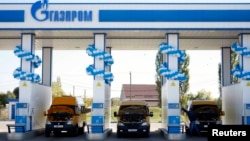 Vehicles are seen at a gas filling station, owned by Gazprom Transgaz Stavropol, with the company logo of Russian natural gas producer Gazprom on the station, in Stavropol