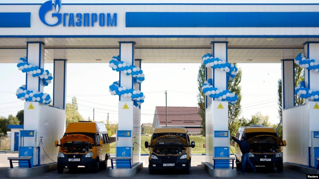 Vehicles are seen at a gas filling station, owned by Gazprom Transgaz Stavropol, with the company logo of Russian natural gas producer Gazprom on the station, in Stavropol