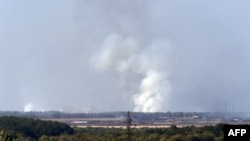 Smoke rises after a weapons factory controlled by pro-Russian militants exploded near Donetsk on September 20.