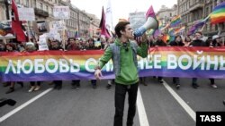 LGBT activists carrying a banner reading "Love Is Stronger Than War" in 2014. Russia has moved to ban transgender people from having driver's licenses.