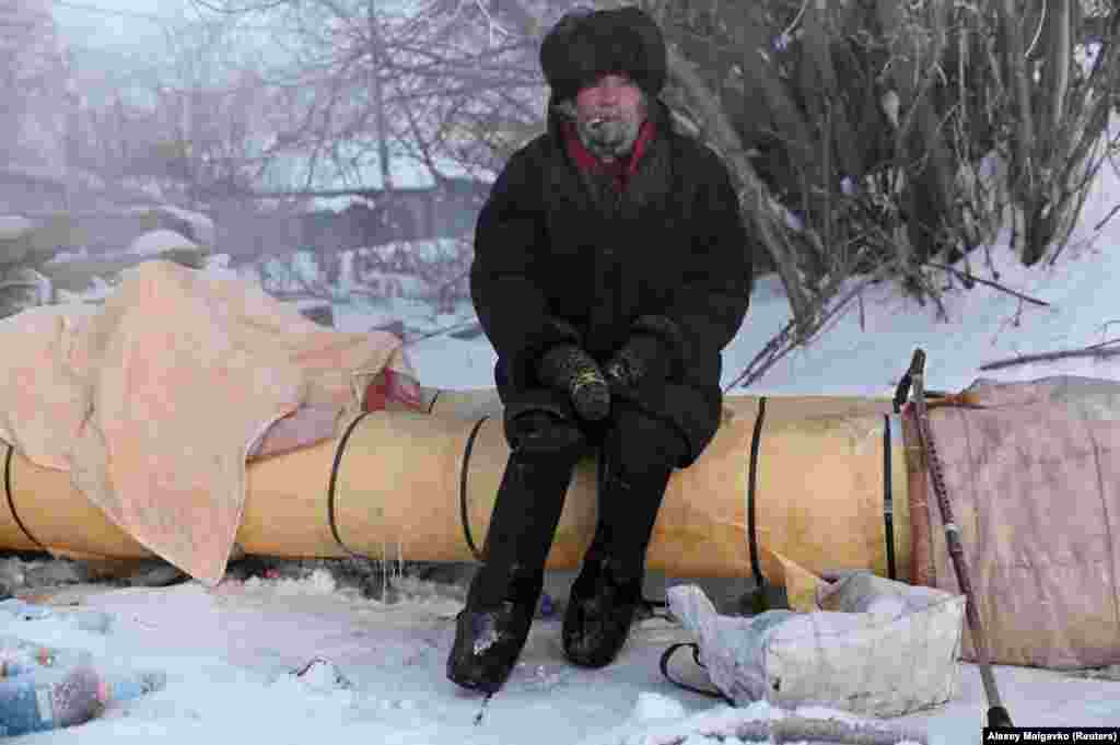 Oleg, 57, nicknamed &quot;Khudozhnik&quot; (Artist), sits 300 meters away from an apartment block where he used to live.