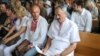 Union leaders Ihar Komlik (left) and Henadz Fyadynich appear in court on July 30.