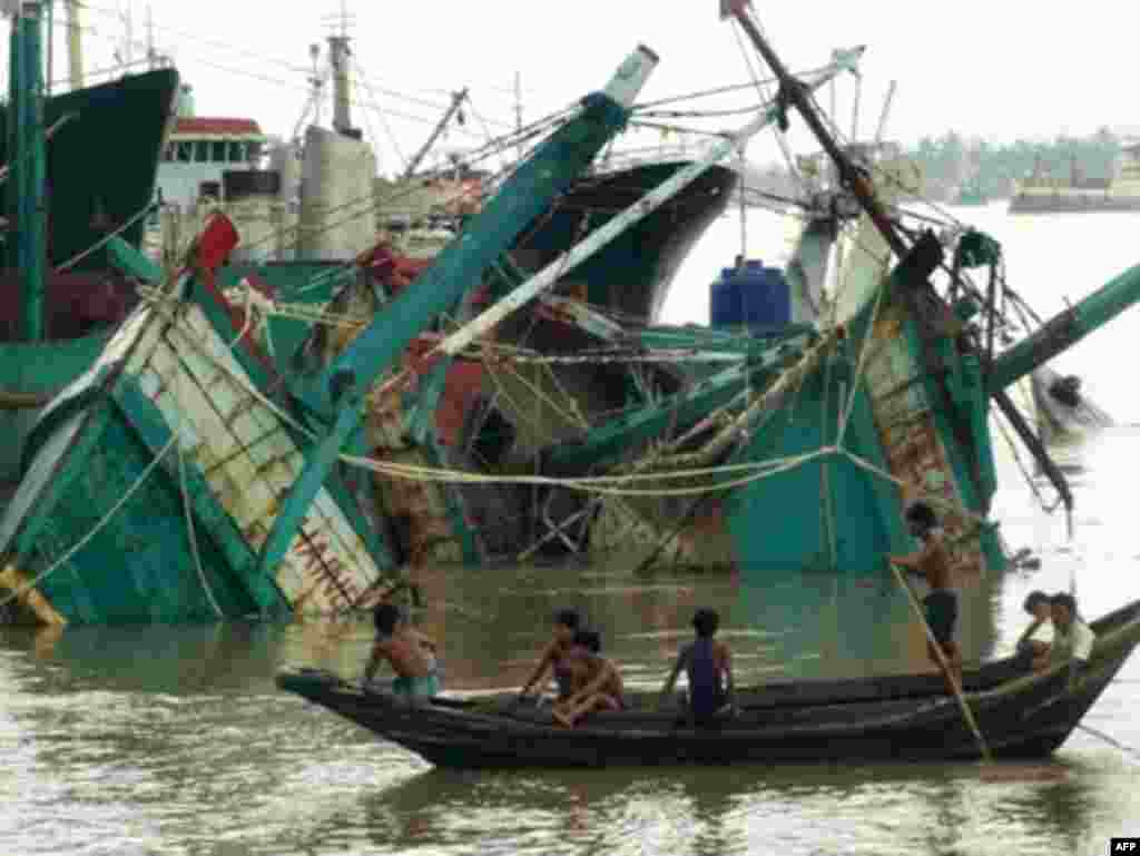 Myanmar hit by tropical cyclone Nargis - Destroyed fishing boats lay in the port of Yangon after cylone Nargis on May 4, 2008. Myanmar residents awoke to devastation after tropical cyclone Nargis tore through swathes of the country, battering buildings, sinking boats and causing unknown casualties.