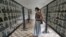 A foreign tourist pauses to look at portraits of those killed by Pol Pot and his regime at Touel Sleng prision, in Phnom Penh, Cambodia.