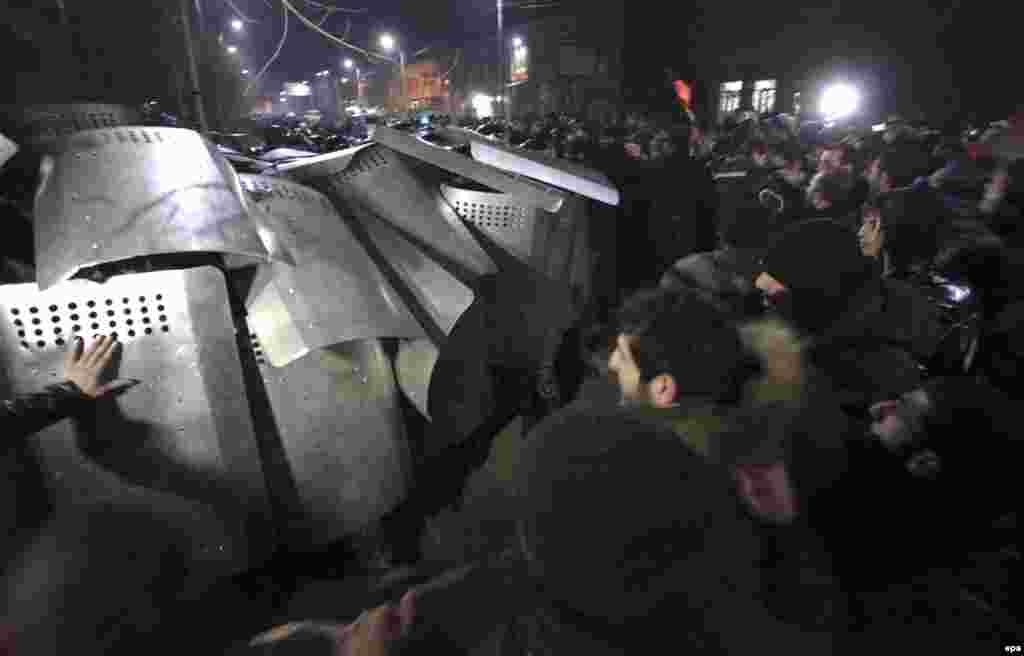 Protesters clash with police during a protest outside the Russian Consulate in the city of Gyumri, Armenia, on January 15. At least 15 people were injured in the clashes. Protesters are demanding the handover of a Russian soldier accused of murdering six members of an Armenian family near Russia's military base in the former Soviet republic. (epa/Vahram Baghdasarian)