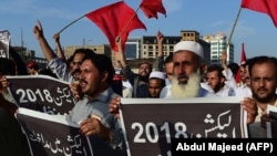 Supporters of Awami National Party (ANP) protest against alleged election rigging in Peshawar on July 30.