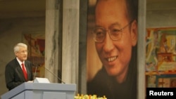 Norwegian Nobel committee chairman Thorbjoern Jagland speaks during the Nobel Peace Prize ceremony in Oslo on December 10, in front of honoree, Chinese dissident Liu Xiaobo.