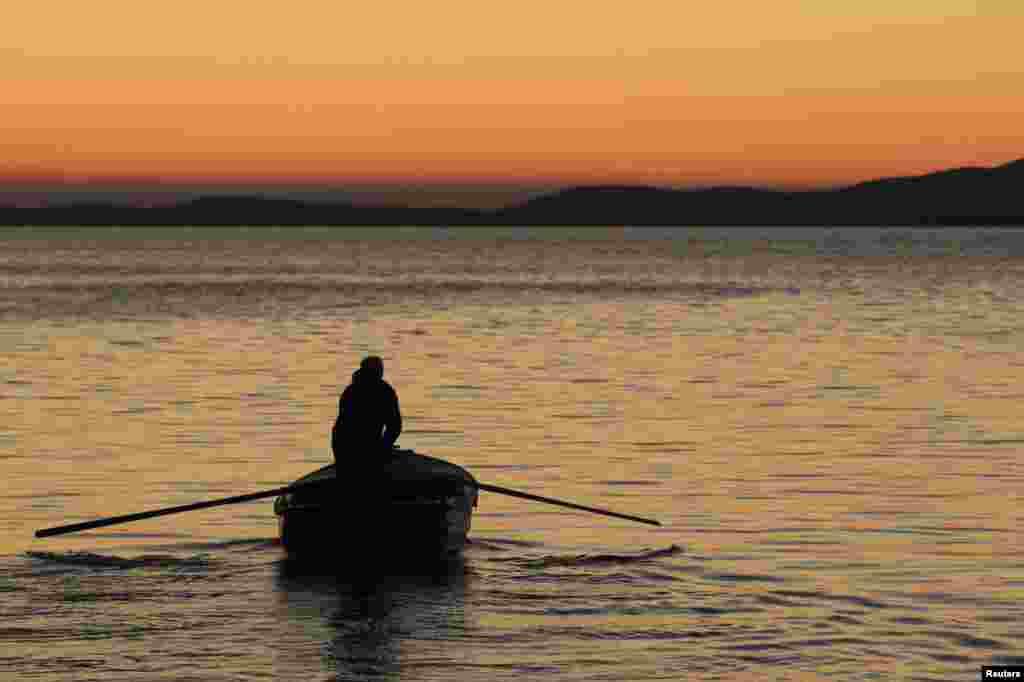 A fisherman rows a boat during sunset in Lun, southern Croatia. (Reuters/Antonio Bronic)