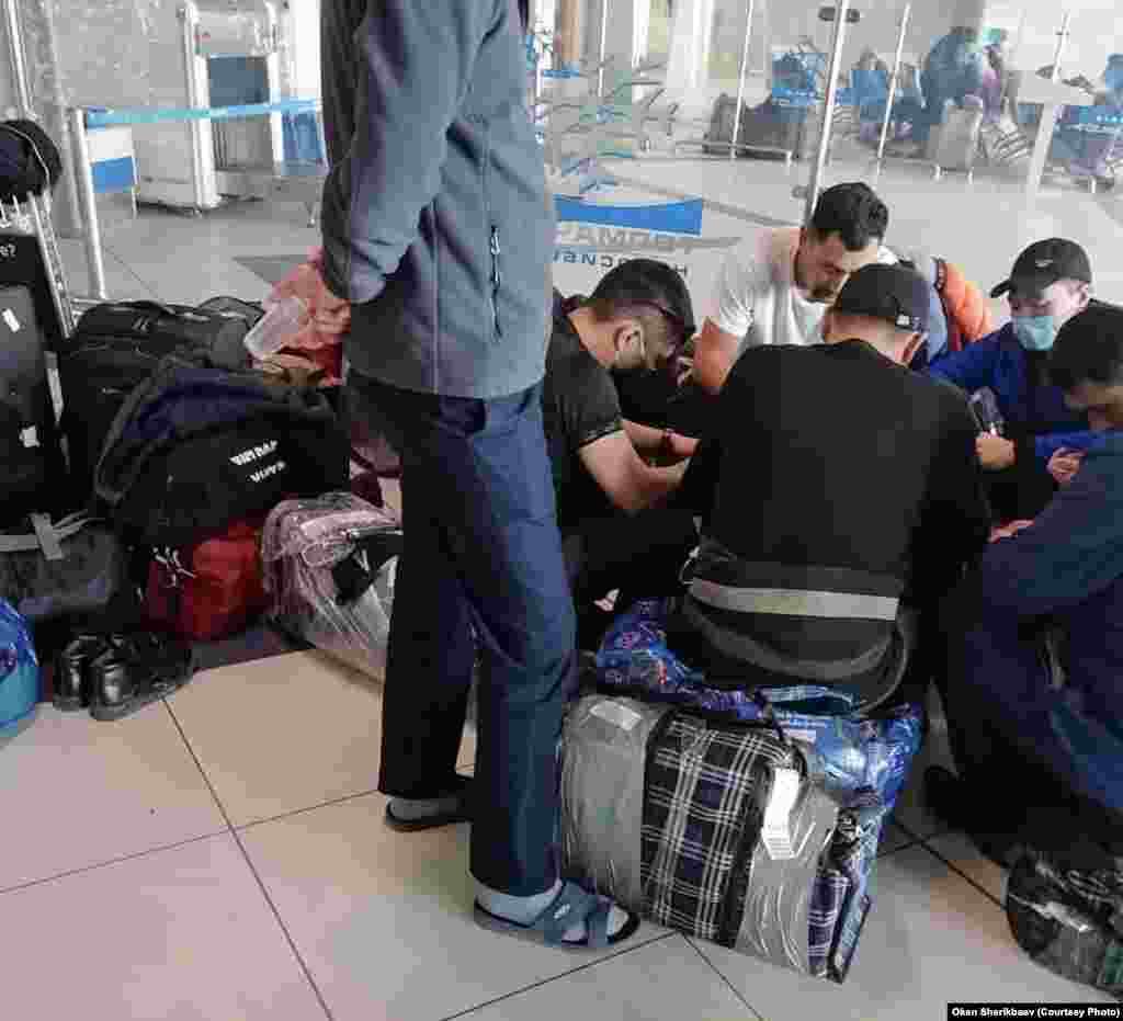 Kyrgyz migrants wait at Tolmachevo Airport in Novosibirsk on March 31. About 200 people have been living at the airport since March 27, when both Kyrgyzstan and Russia canceled international flights in a bid to stop the spread of the coronavirus. 
