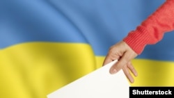 Generic -- ©Shutterstock Female hand with ballot and box on Flag of Ukraine