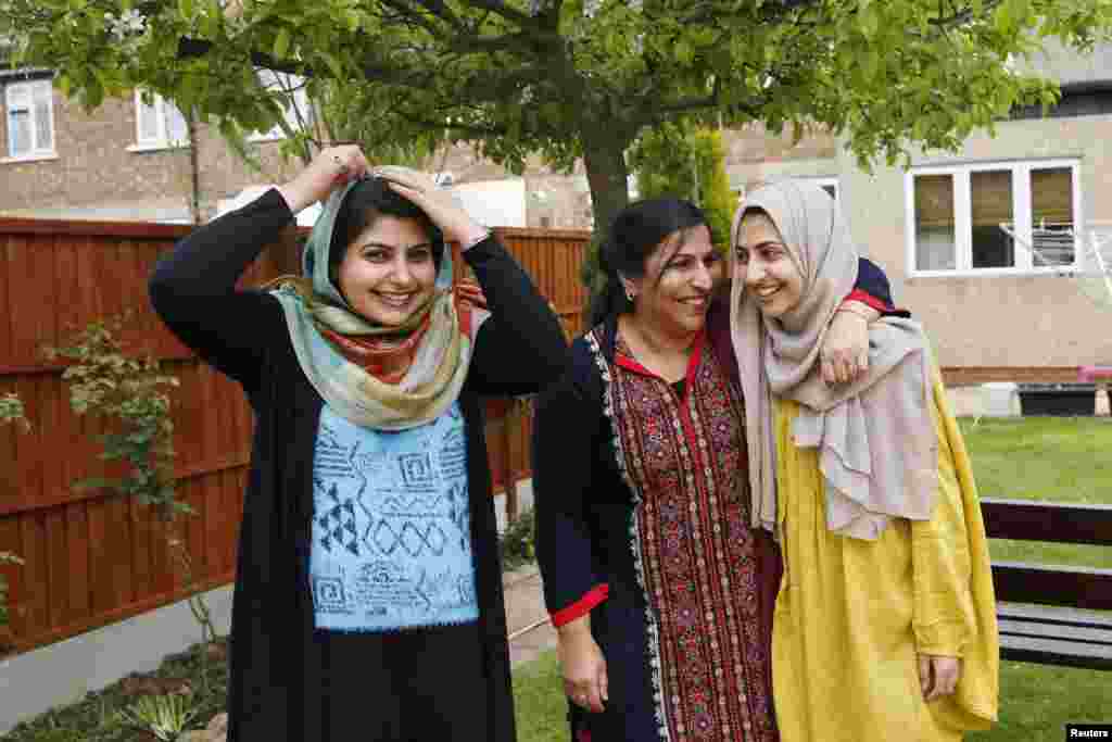 Sundas (left), her mother, Naheed (center), and her sister, Shanza, at their home in Walthamstow, east London. Sundas and Shanza started wearing the hijab in opposition to their parents' wishes. Their mother doesn't cover her head and didn't approve of her daughters' strict interpretation of Islam.