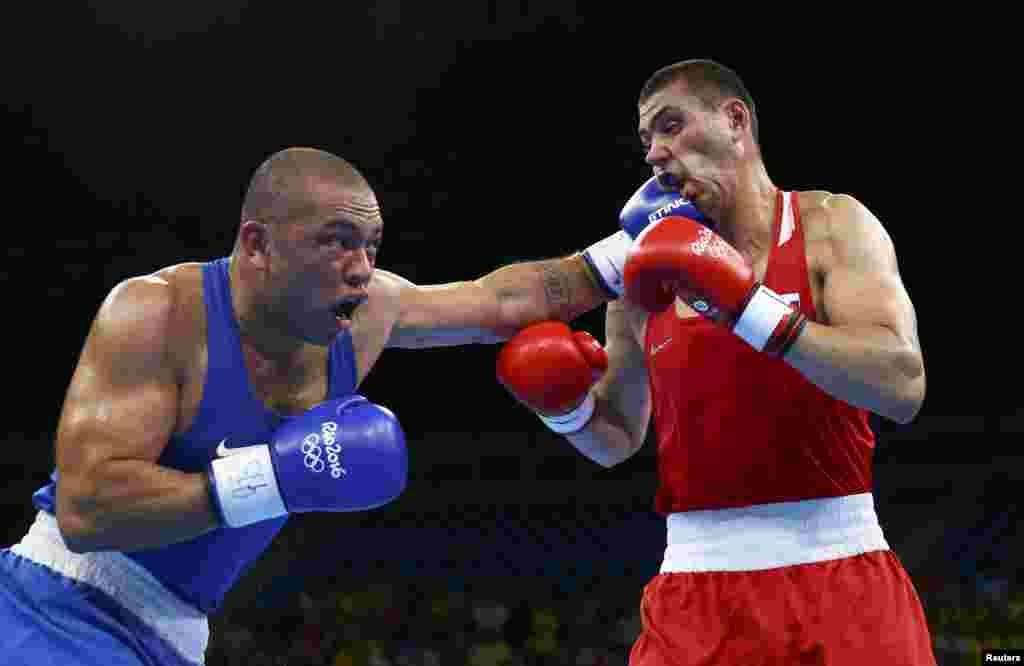 Juan Goncalves Nogueira of Brazil (left) lands a punch on Yevgeny Tishchenko during their men's 91-kilogram boxing event, won by Tishchenko.