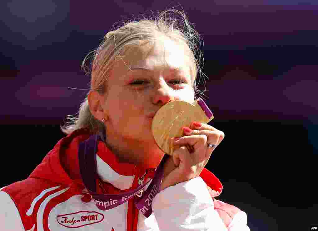 Russia&#39;s Margarita Goncharova poses with the gold medal after winning a women&#39;s long jump event.