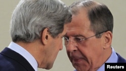 U.S. Secretary of State John Kerry (left) talks with Russian Foreign Minister Sergei Lavrov at the start of a NATO-Russia foreign ministers meeting in Brussels on April 23. 