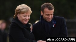German Chancellor Angela Merkel (Left) and French President Emmanuel Macron take part in a ceremony on November 10.