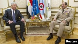 Egyptian Defense Minister General Abdel Fattah al-Sissi (right) meets with U.S. Defense Secretary Chuck Hagel in Cairo on April 24.