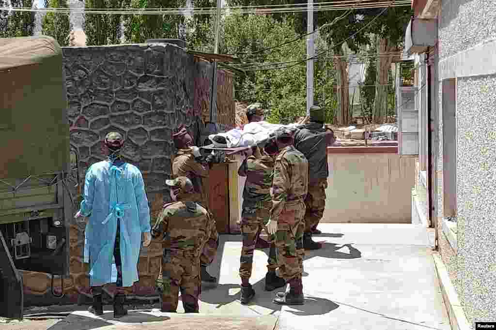 Indian army soldiers carry the body of their colleague, who was killed in a border clash with Chinese troops, to an autopsy centre at the Sonam Norboo Memorial Hospital in Leh, June 17, 2020.&nbsp;