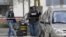 Police officers work near the site where Rahim Namazov and his wife were targeted by gunfire in Colomiers, France.