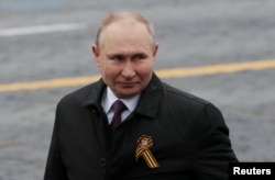 Russian President Vladimir Putin walks along Red Square after a military parade on May 9.