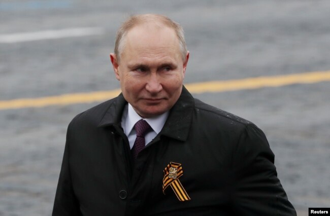 Russian President Vladimir Putin walks along Red Square after a military parade on May 9.