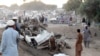 Pakistanis gather at the site of the bomb blast in Bannu on November 26.