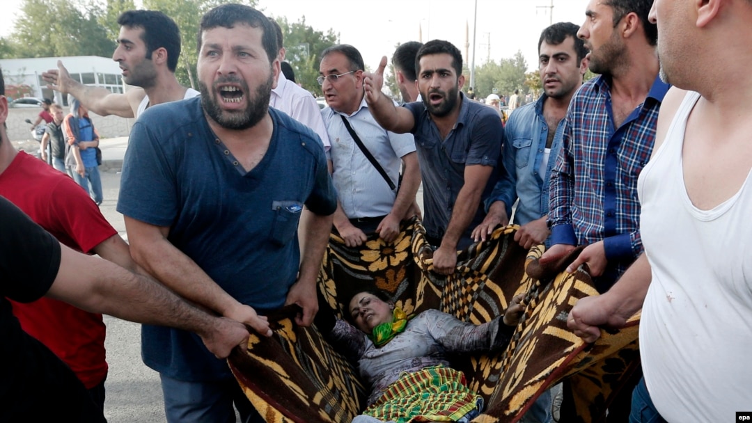 People help wounded victims after an explosion during a election campaign rally for the Peoples' Democratic Party (HDP) in southeastern Turkey. 