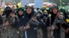 Members of Iran's Basij militia force march with rifles during a military rally in Tehran on September 18.