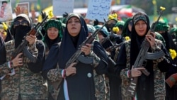 Members of Iran's Basij militia force march with rifles during a military rally in Tehran on September 18.